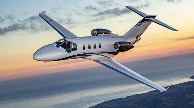 bizav salary data - private jet in sky with sunset - Aviation Week Operations Planning Guide