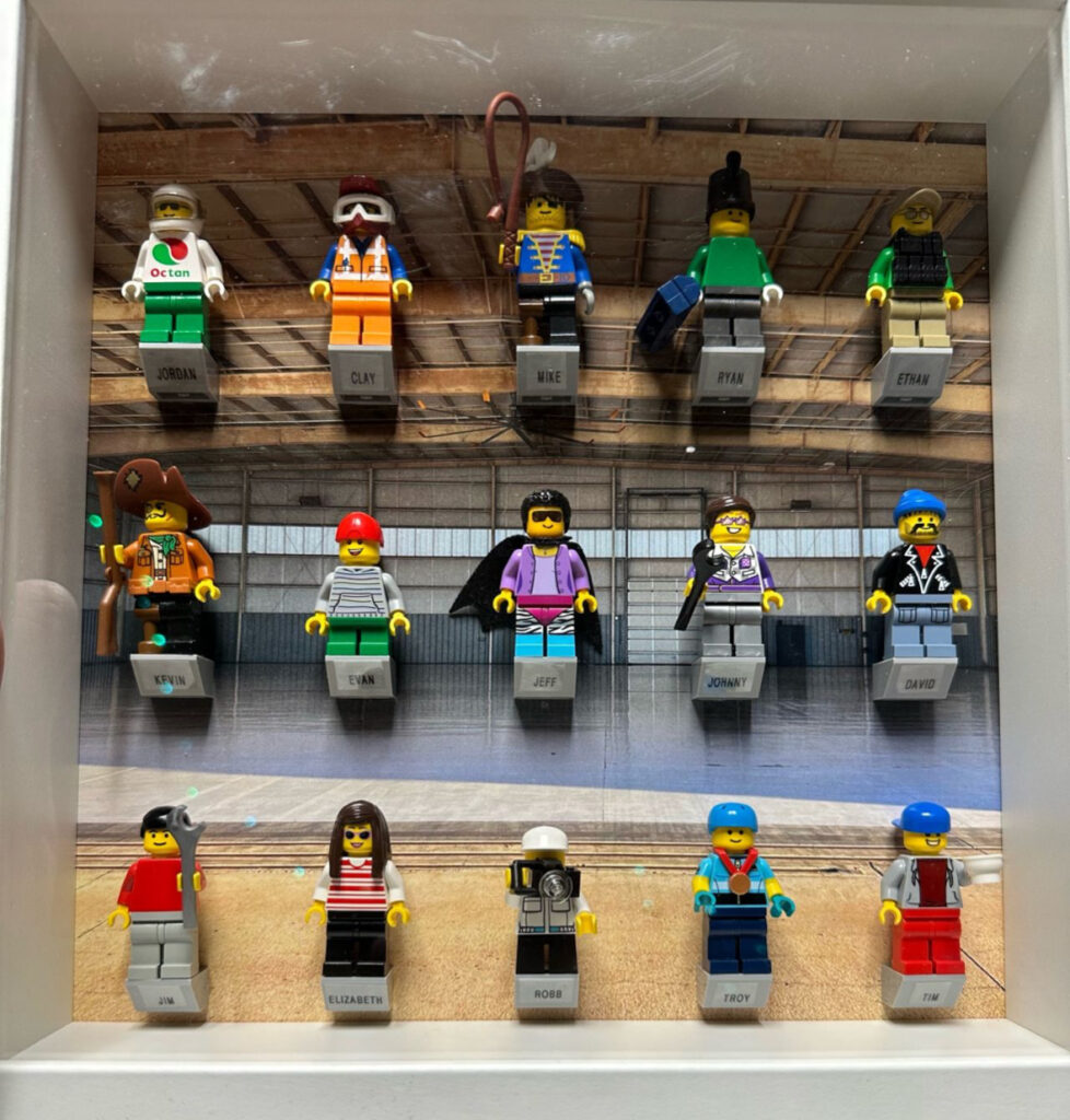 Shadow box of Lego Minifigurines designed to represent each person in the flight department. Goal is to build culture and bring levity to workplace.