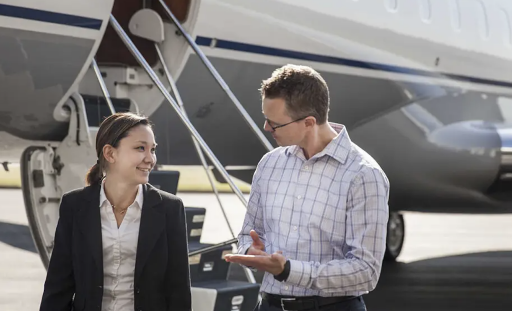 Reverse mentoring - image of woman and man talking in front of jet stairs on tarmac